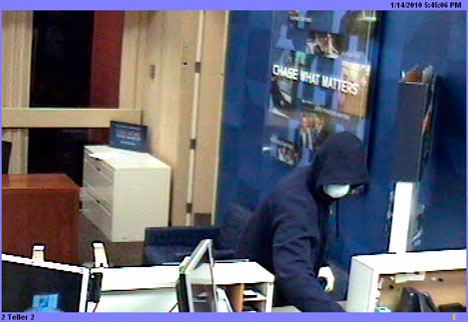 A masked man approaches the counter at the Freeland Chase Bank Thursday during a robbery in this photo released by the Island County Sheriff's Office.