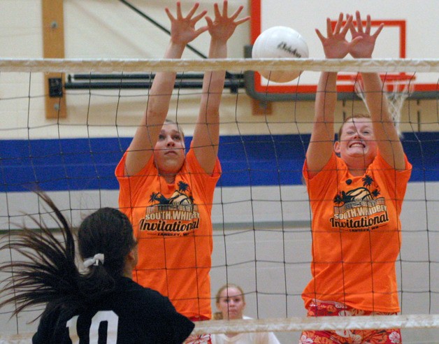 South Whidbey sophomores Abby Hodson and Anne Madsen miss a block against Shoreline Christian. South Whidbey split its second match at the school’s tournament.