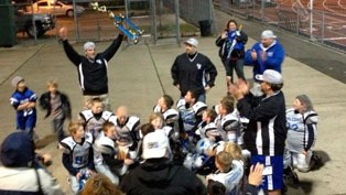 The South Whidbey Youth Football Association team hoists its 2012 trophy after winning the North County Youth Football Association super bowl.