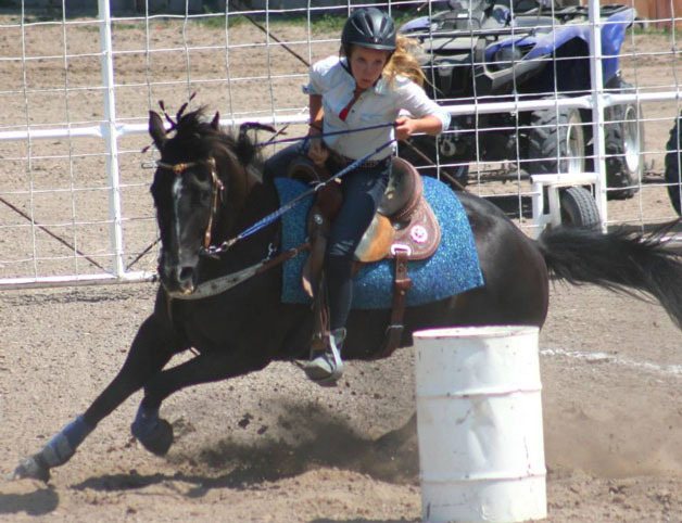 Thandeka Brigham turns her horse Molly around a barrel during the O-Mok-See National Championship in early July. The 15-year-old Langley girl won the 12 to 15-year-old girls division title and a trophy saddle.