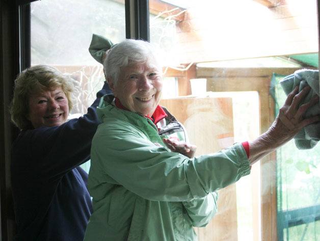 Mary Richardson and Loretta Wilson let a bit more light into one home by cleaning windows  during the Hearts & Hammers work day. The day brightened the lives of many homeowners on South Whidbey by providing rapairs to homes of those in need.