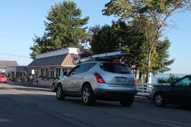 A car drives by the Village Pizzeria lot