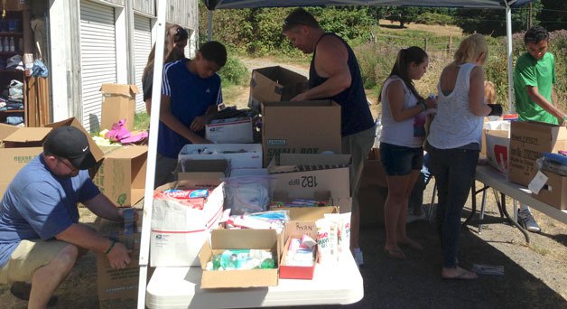 Youths from the Seattle-area sort items with Ryan’s House For Youth