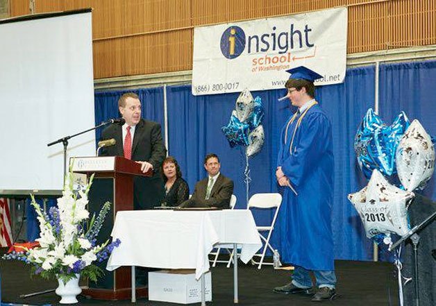 John Goettle listens as Insight School of Washington principal introduces him as the school’s student of the year. Goettle