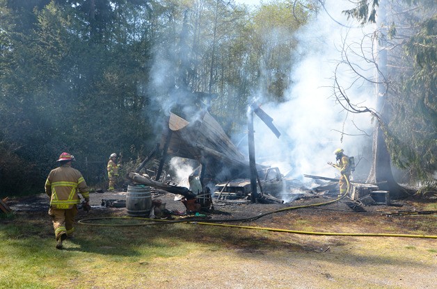 Firefighters from South and Central Whidbey battle a barn fire in Greenbank Saturday. The structure was owned by David and Terri Schaal and was a complete loss. A cause was undetermined.