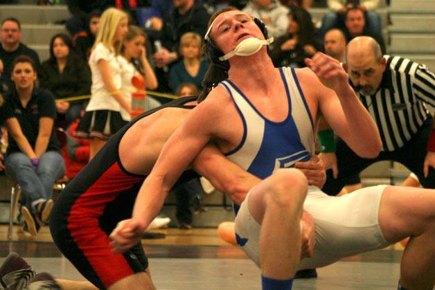 Montana Johnson works out of Cedarcrest senior Alex Heuter’s grasp during the 160-pound bout at the conference tournament.