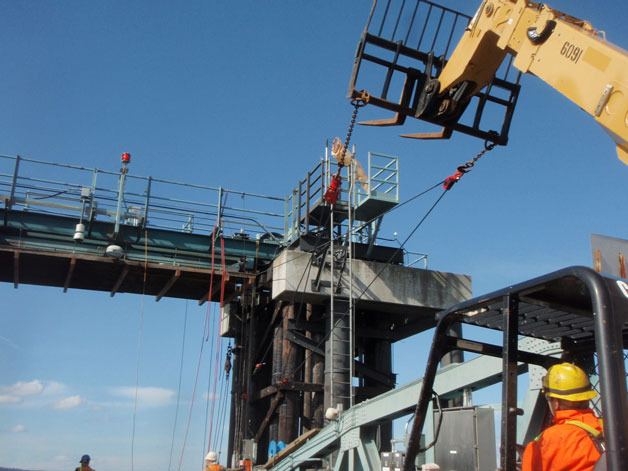 A crew at the Mukilteo Ferry Terminal install a new bridge hoist cable during the recent repair work at the terminal.