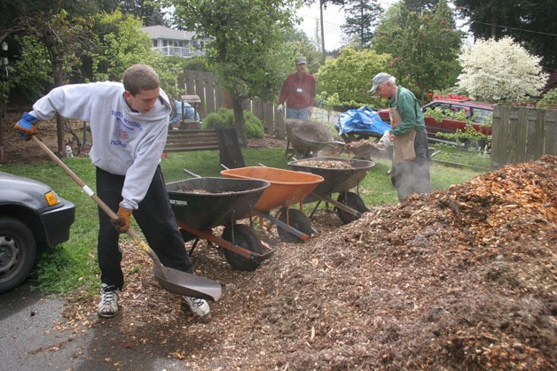 Volunteers with Hearts & Hammers spread mulch at a Sunlight Beach-area home during last year's workday. Hearts & Hammers is still accepting applications from homeowners who would like help during this year's workday in May.