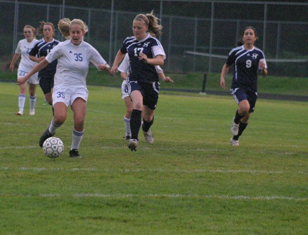 Hayley Newman battles for possession against Sultan. Newman finished with three shots on goal and helped South Whidbey get its second win of the season and sweep the Turks this year.