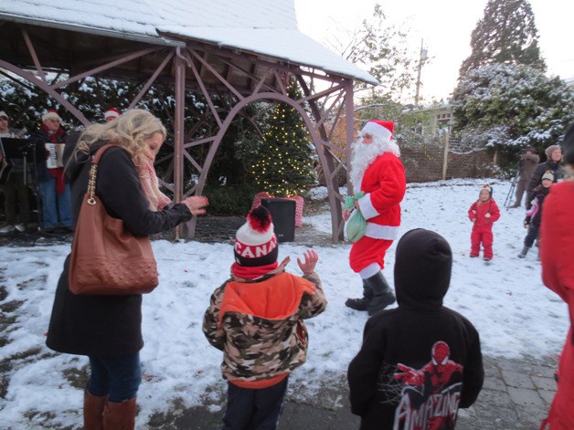 Children gather around Santa Claus at Langley Park during the Lighting of Langley ceremony Saturday