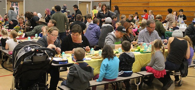 Kindergartners and their families munch on food prepared by South Whidbey Elementary students at the first annual Thanksgiving Feast on Nov. 17.