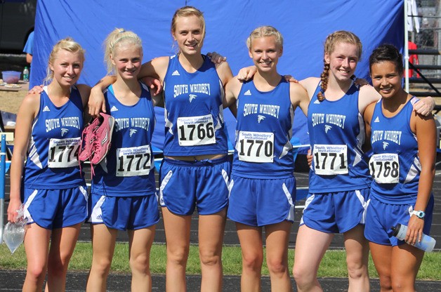 The Falcon girls cross country team basks in the sun and victory after finishing in first place in the Division 2 girls race at the South Whidbey Invitational on Saturday