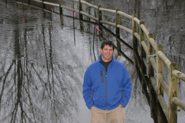 Clinton resident Craig Williams stands on submerged Deer Field Lane
