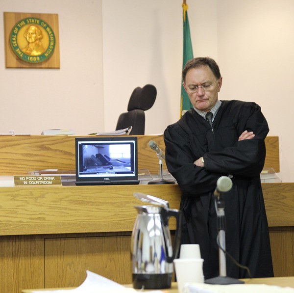 District Court Judge Bill Hawkins watches a video to determine if it’s admissible as evidence in a case against Whidbey General Hospital Chief Nursing Officer Linda Gipson. She is accused of assaulting a patient.