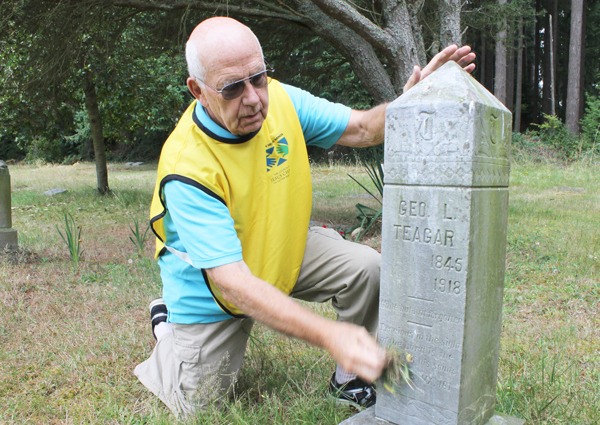 Frank Thornton pulls weeds around a gravestone at Bayview Cemetery. He and other volunteers will gather for the annual clean-up on Saturday.