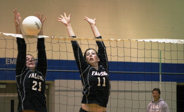 South Whidbey senior setter Emily Houck (21) blocks a King's kill on Tuesday night as junior blocker Hannah Calderwood leaps to defend as well.