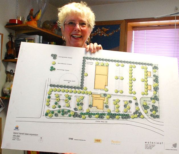Island Transit Director Martha Rose holds up the layout design for the new headquarters in Coupeville. A contract with an Everson-based construction firm has been conditionally approved and groundbreaking is planned for April 10.