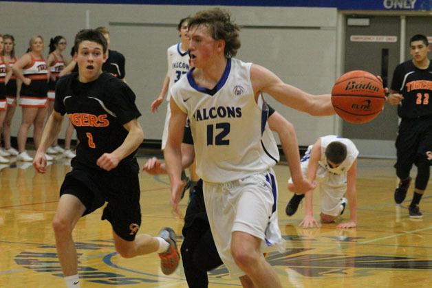 Falcon senior Chase White dribbles past Tiger defenders during South Whidbey’s 52-50 loss to Granite Falls on Jan. 5.