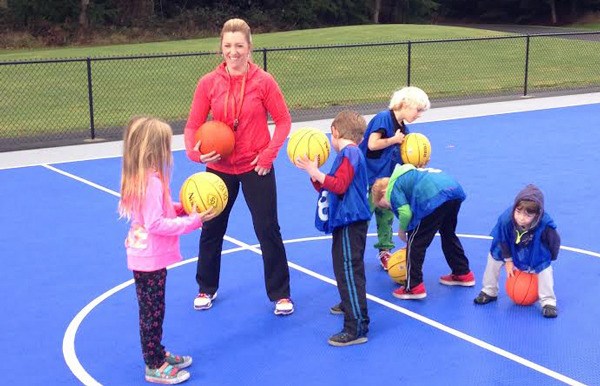 Erin Mackie-Ratcliff works with Little Dribblers on the court during the grand opening ceremony.