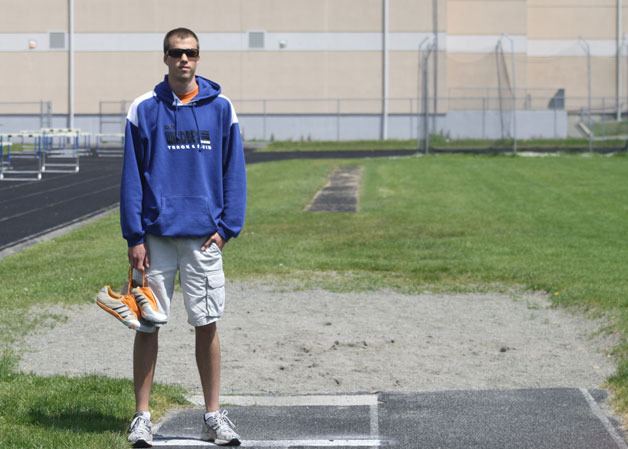 Falcon senior Will Hallberg stands next to the place where he’s made his mark: near the triple-jump and long-jump pit at Waterman Field where he set the school record.