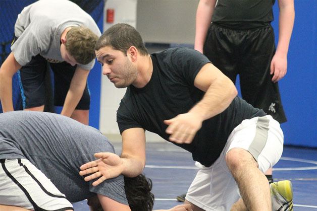 Langley Middle School wrestling head coach Robbie Bozin teaches technique at a recent practice.