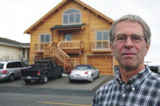 New diking district commissioner John Shepard outside the house he’s completing on Sunlight Beach Road: “We’re not even being benefited.”