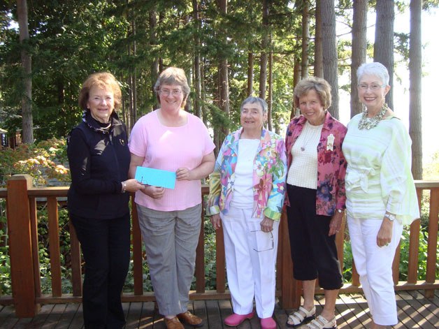 Robin Bridges accepts a grant from Langley PEO Chapter GJ president Louise Prewitt with support from education committee members Midge Billig