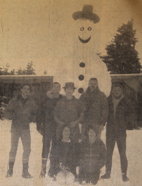 Laying their claim to building the largest snowman on South Whidbey during the present cold spell are the youngsters shown above with their creation