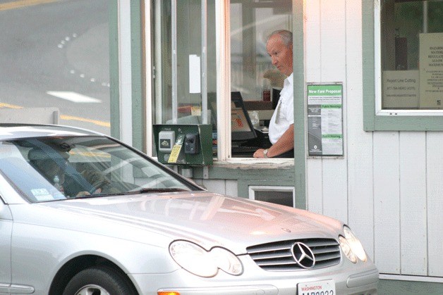 Clinton Ferry Terminal worker Stan chats with a commuter at the toll booth.