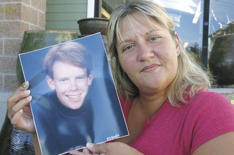 Lori Cavender of Langley with a photo of her late god-brother