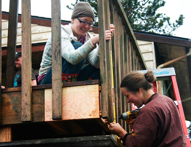 Volunteers mend a deck during last year’s Hearts & Hammers work day