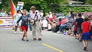 Betty and Jim Lightner march in the Maxwelton Independence Day Parade followed by members of the Whidbey PFLAG chapter on July 4.