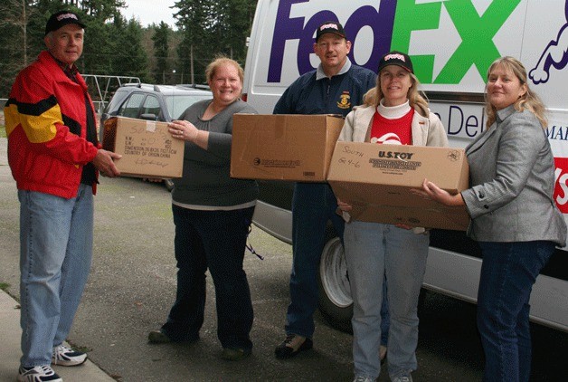 Toys for Tots delivers gifts to Holiday House at South Whidbey Primary School on Monday. From left: Mike McClung