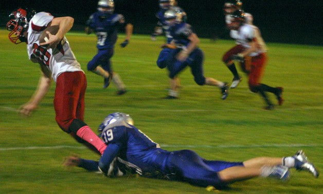 Falcon junior safety Nick French makes this diving tackle against Coupeville on Oct. 12.