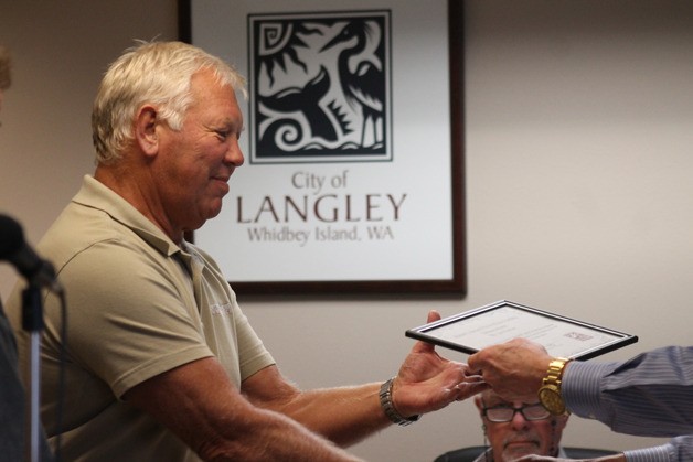 Jim Porter receives an award from Langley Mayor Fred McCarthy for remodel work on his commercial building on Anthes Avenue at the June 1 council meeting.