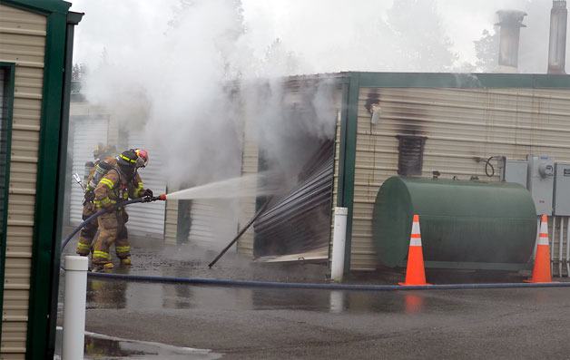 South Whidbey Fire/EMS firefighters douse a fire at the A-OK storage facility in Freeland on Saturday. The blaze was out quickly but resulted in an estimated $85