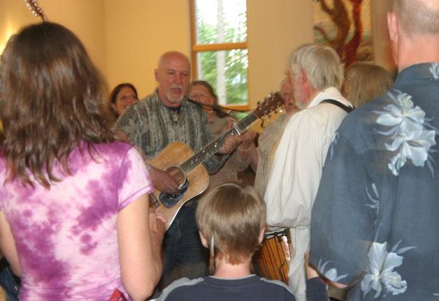 Michael Sheehan on guitar helps to lead the Dances of Universal Peace each month in Freeland.