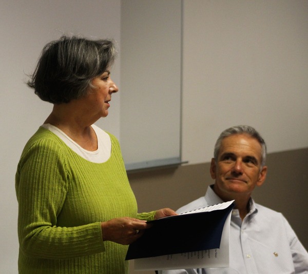 Linda Beeman reads from her book of poems entitled “Collateral Damage” at the Oak Harbor Library Thursday afternoon as Greg Stone
