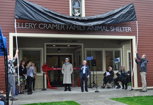 Whidbey Animal Improvement Foundation officials unveil the name of their new facility in Coupeville during a ceremony this past weekend. It was named in honor of stalwart supporter Ellery Cramer