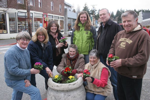 Getting ready to plant primroses at Boy and Dog Park in downtown Langley are (standing from left) Mary Ann Mansfield