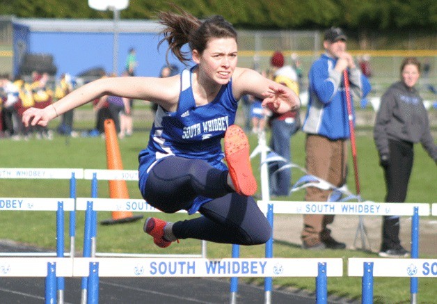 Sylvie Kaul-Anderson hurdles toward the finish line during South Whidbey’s track and field jamboree on Thursday. Kaul-Anderson