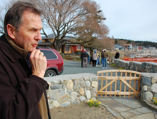 Greenbank property owner Bruce Montgomery speaks to a reporter during a community demonstration on Wonn Road in early 2009. Island County is suing Montgomery for a wall he built on property that may be a public beach access.