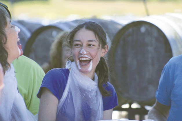 Kelly Uhlig shares a laugh with her fellow pie-eating contestant Saturday. Uhlig didn’t win first place