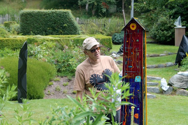 Freeland-based glass artist Dale Reiger ensures one of his recognizable glass house pieces is spick and span before the 2016 Froggwell Biennale.