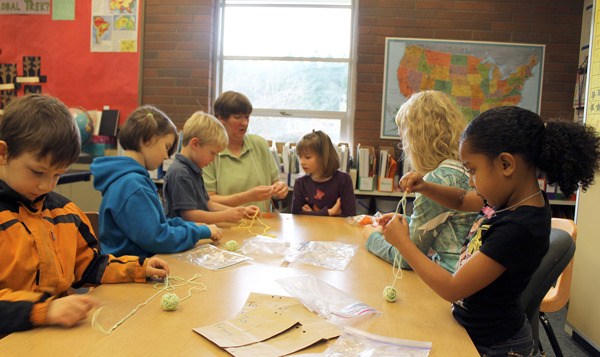 South Whidbey Academy teacher Jean Cravy assists a group of students during a recent Fiber Arts class.