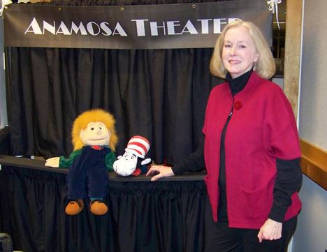 Marti Animosa stands next to the puppet stage that now bears her name.