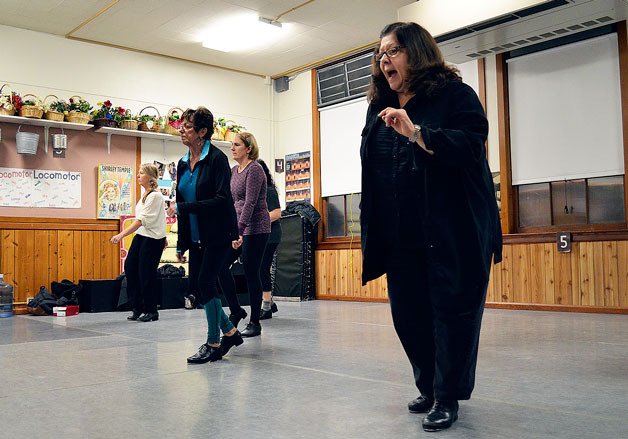 Island Dance owner Charlene Brown teaches a dance step to students