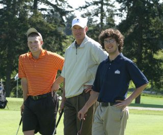 Falcon golfers Brooks Guetlin and Perry Cooley flank coach Steve Jones during putting practice at Useless Bay Golf Club.
