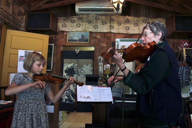 Island Strings owner Linda Good (right) instructs one of her pupils