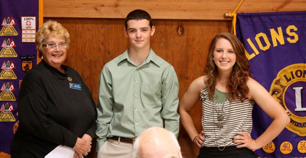 Rosemary Martin congratulates Lions Club scholarship recipients David Kay and Alissa Coupe.